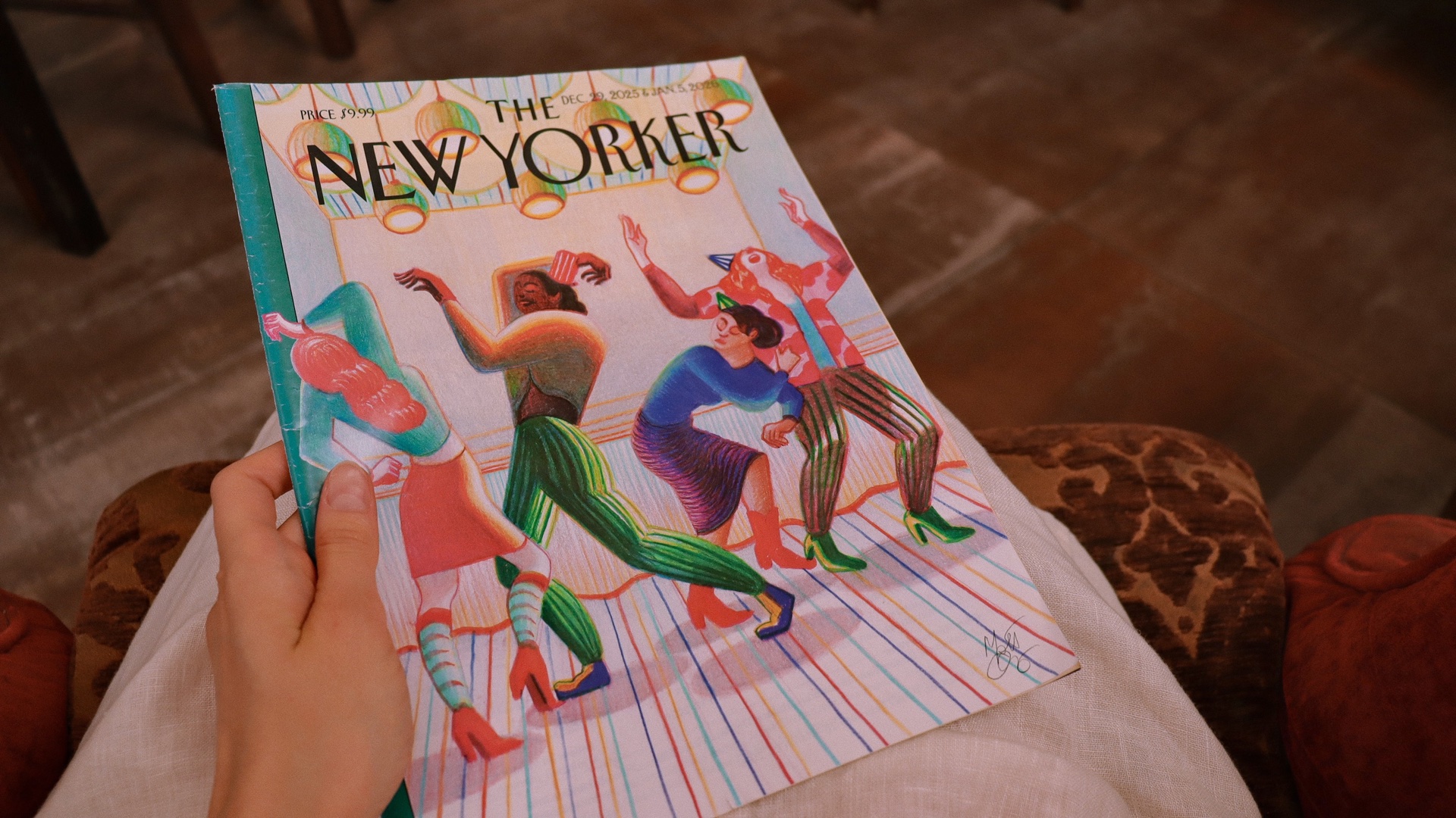 The New Yorker magazine held in a cozy cafe, perfect for lifestyle, reading, and slow travel imagery