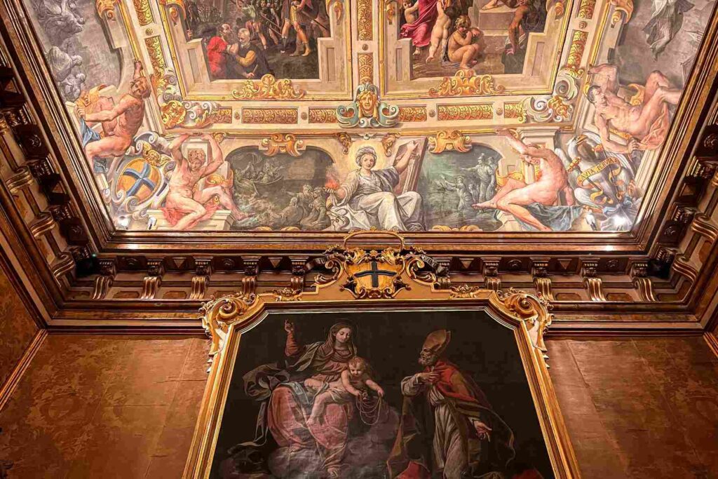 Ornate frescoed ceiling and religious painting in Modena