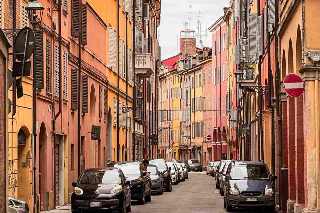 Narrow street with colorful houses in Modena, Italy