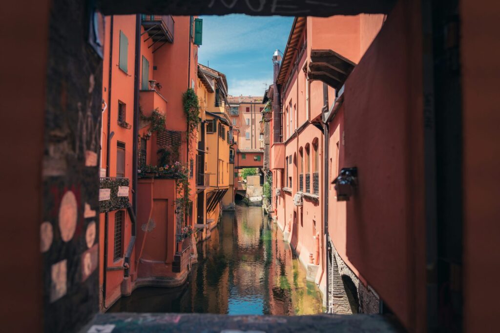 Canal and colorful buildings in Bologna for planning how many days to stay in Emilia-Romagna