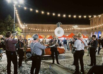 Outdoor live music event with string lights in Italy