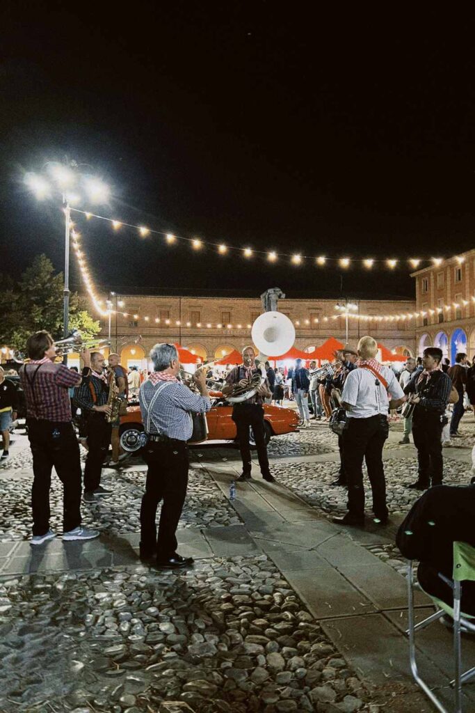 Outdoor live music event with string lights in Italy