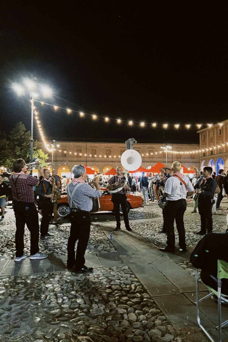 Outdoor live music event with string lights in Italy