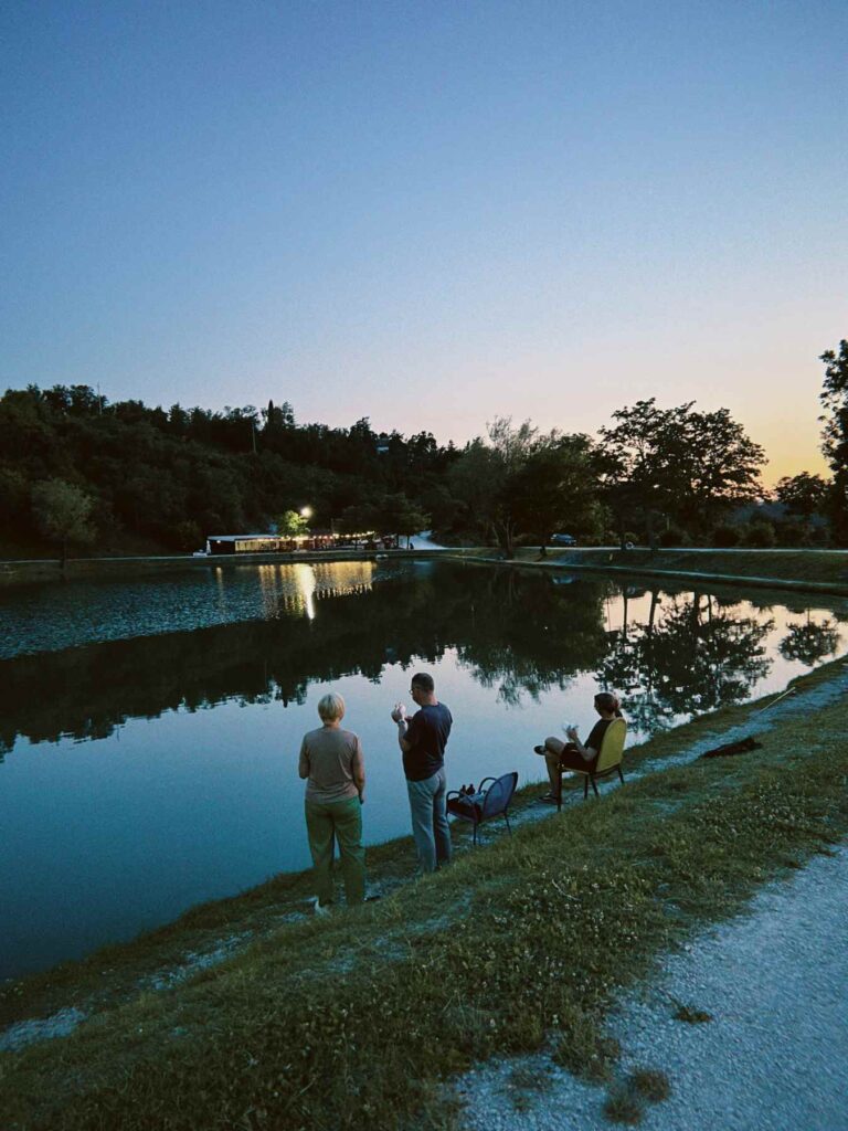 Sunset walk beside a lake in the Italian countryside